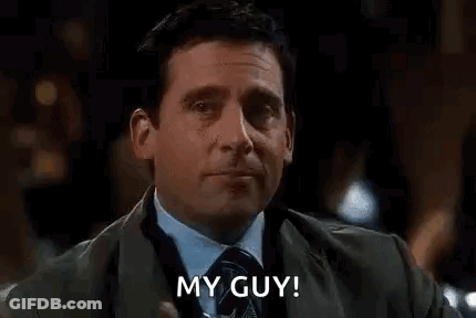 A Man In A Suit And Tie Is Drinking A Martini And Saying `` My Guy ! '' GIF