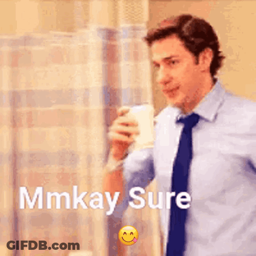 A Man In A Suit And Tie Is Drinking From A Cup And Says Mmkay Sure . GIF
