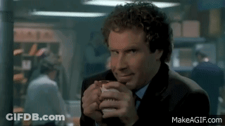 A Man In A Suit And Tie Is Drinking From A Cup GIF