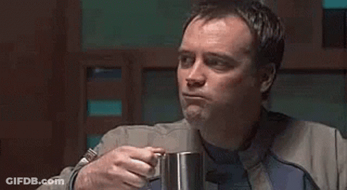 Man In Suit Drinking From Mug GIF
