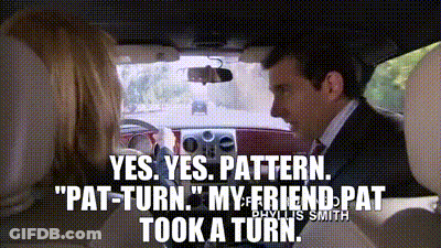 A Man In A Suit And Tie Is Driving A Car And Talking To A Woman . GIF