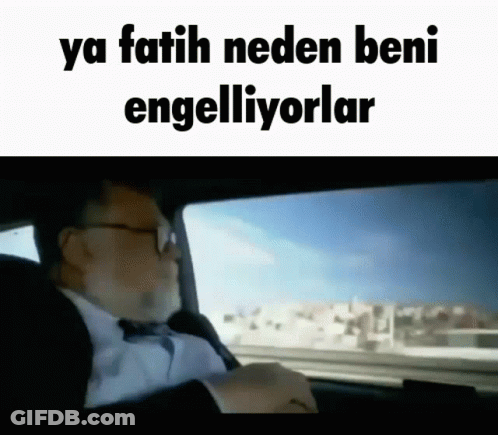 A Man In A Suit And Tie Is Driving A Car With The Words " Ya Fatih Neden Beni Engelliyorlar " On The Bottom GIF