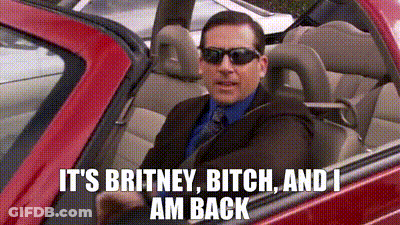 A Man In A Suit And Tie Is Driving A Red Car With The Words `` It 'S Britney Bitch And I Am Back '' GIF