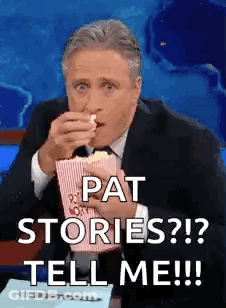 A Man In A Suit And Tie Is Eating Popcorn And Saying `` Pat Stories ? ! ? Tell Me ! '' GIF
