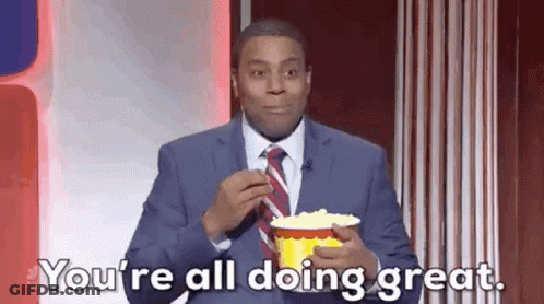 A Man In A Suit And Tie Is Eating Popcorn And Says `` You 'Re All Doing Great . '' GIF