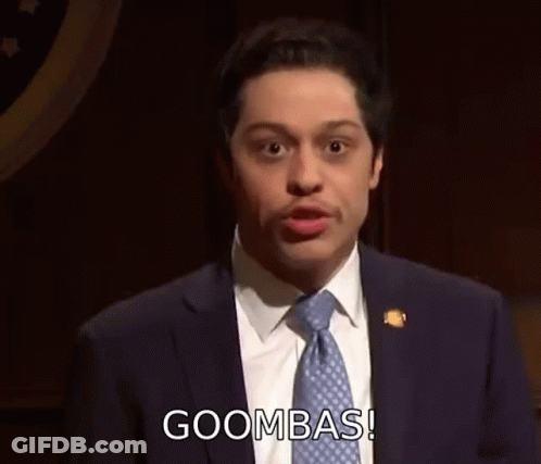 A Man In A Suit And Tie Is Giving A Speech . GIF