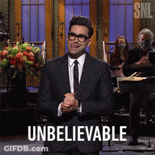A Man In A Suit And Tie Is Giving A Speech And The Word Unbelievable Is On The Screen GIF