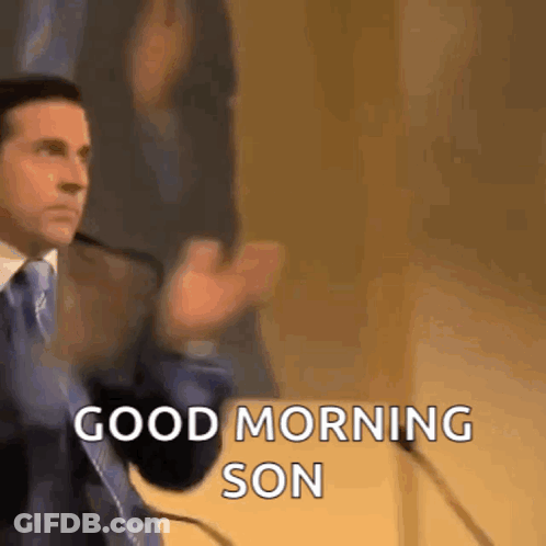 A Man In A Suit And Tie Is Giving A Speech In Front Of A Microphone And Saying `` Good Morning Son '' . GIF