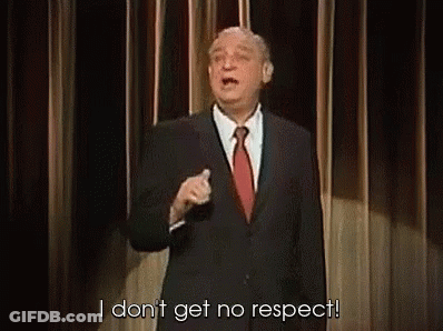 A Man In A Suit And Tie Is Giving A Speech On A Stage And Saying `` I Don T Get No Respect '' GIF