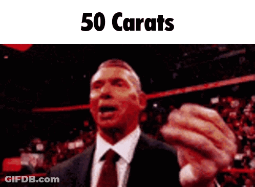 A Man In A Suit And Tie Is Giving A Speech With The Words 50 Carats Below Him GIF