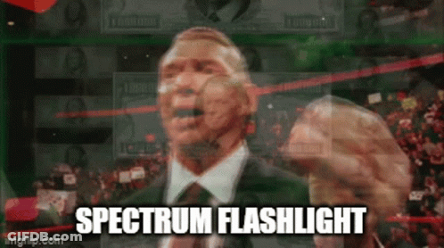 A Man In A Suit And Tie Is Giving A Speech With The Words Spectrum Flashlight Written Below Him GIF