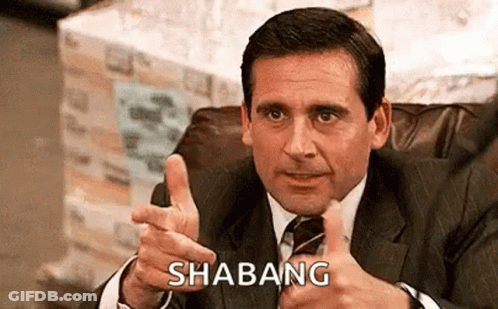 A Man In A Suit And Tie Is Giving A Thumbs Up And Pointing . GIF