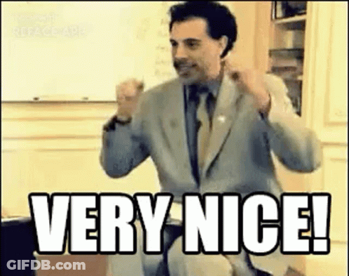 A Man In A Suit And Tie Is Giving A Thumbs Up And Saying `` Very Nice ! '' GIF