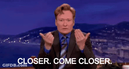A Man In A Suit And Tie Is Giving A Thumbs Up And Says Closer Come Closer . GIF