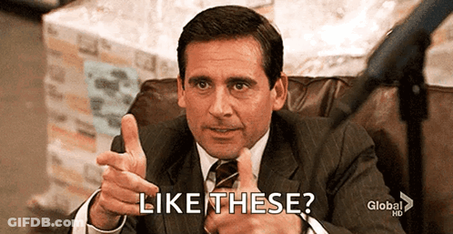 A Man In A Suit And Tie Is Giving A Thumbs Up And Says Like These . GIF
