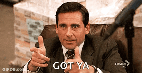 A Man In A Suit And Tie Is Giving A Thumbs Up And The Words Got Ya Are Behind Him GIF