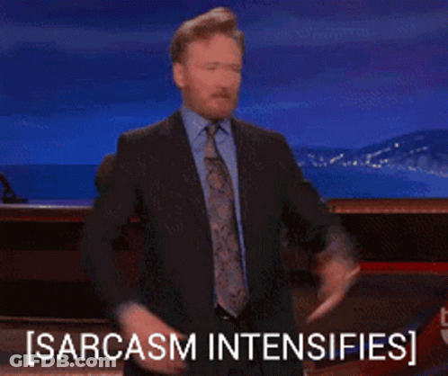 A Man In A Suit And Tie Is Giving A Thumbs Up And The Words Sarcasm Intensifies Behind Him GIF