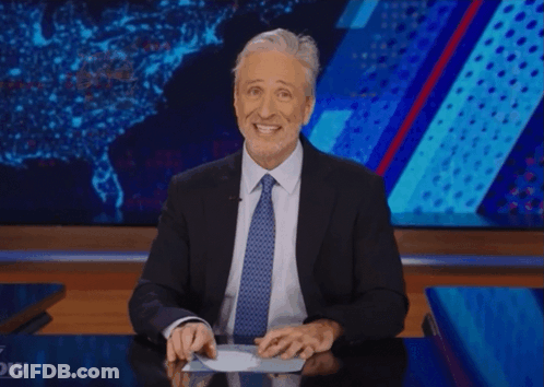 A Man In A Suit And Tie Is Giving A Thumbs Up Sign GIF