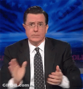 A Man In A Suit And Tie Is Giving A Thumbs Up Sign GIF