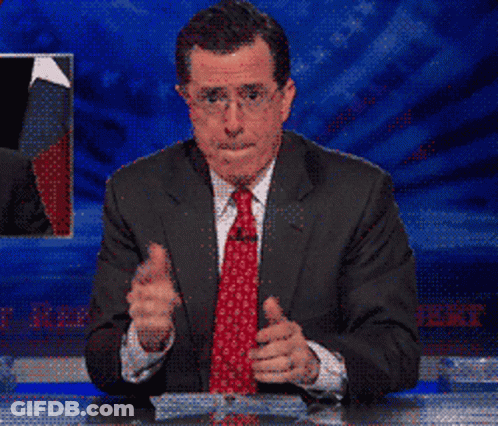 A Man In A Suit And Tie Is Giving A Thumbs Up Sign GIF