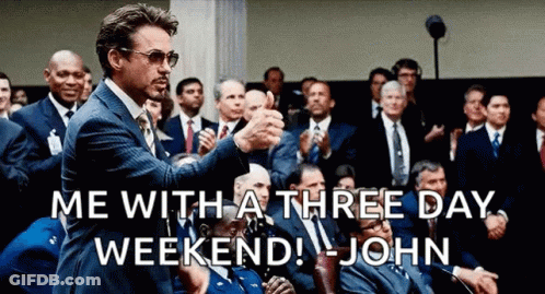 A Man In A Suit And Tie Is Giving A Thumbs Up To A Crowd Of People . GIF