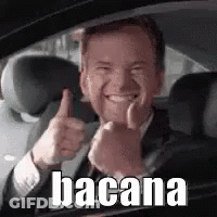 A Man In A Suit And Tie Is Giving A Thumbs Up While Sitting In A Car . GIF