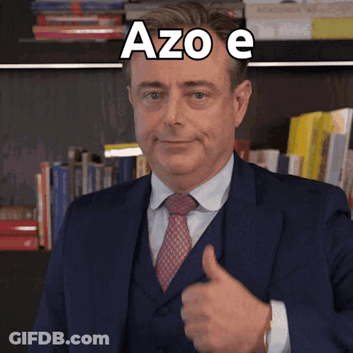 A Man In A Suit And Tie Is Giving A Thumbs Up With Azo E Written Above Him GIF