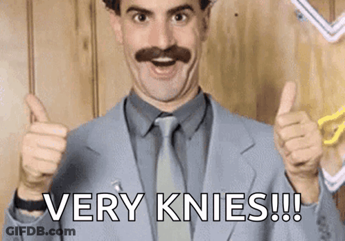 A Man In A Suit And Tie Is Giving A Thumbs Up With The Words Very Knees Written Below Him . GIF
