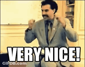A Man In A Suit And Tie Is Giving A Very Nice ! GIF