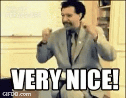 A Man In A Suit And Tie Is Giving A Very Nice ! GIF