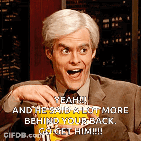 A Man In A Suit And Tie Is Holding A Bag Of M & M 'S Chips GIF