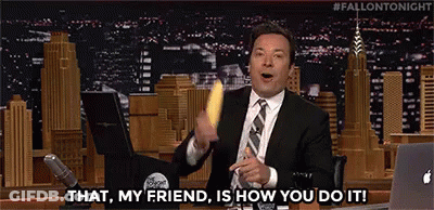 A Man In A Suit And Tie Is Holding A Banana And Saying `` That , My Friend , Is How You Do It ! `` GIF