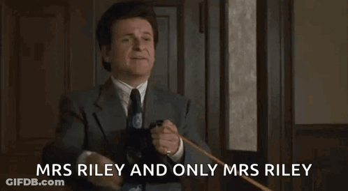 A Man In A Suit And Tie Is Holding A Cane And Giving A High Five . GIF