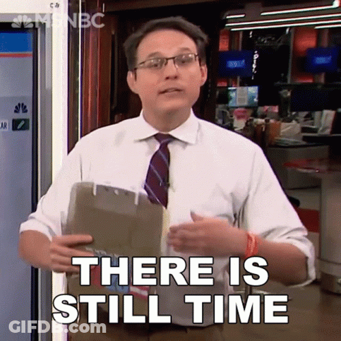 A Man In A Suit And Tie Is Holding A Clipboard And Says There Is Still Time GIF