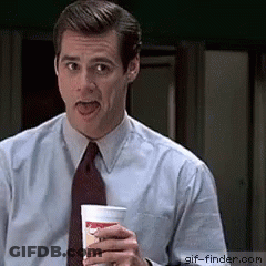 A Man In A Suit And Tie Is Holding A Cup With A Smiley Face On It GIF