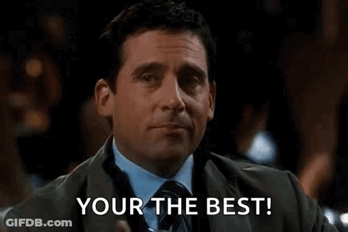 A Man In A Suit And Tie Is Holding A Drink And Pointing At The Camera With The Words `` Your The Best '' . GIF