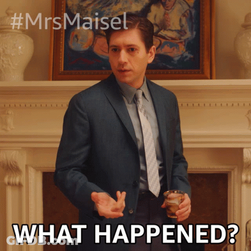 A Man In A Suit And Tie Is Holding A Glass And Says What Happened GIF
