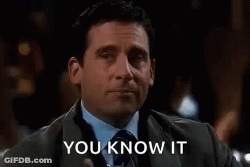 A Man In A Suit And Tie Is Holding A Glass Of Water In His Hand . GIF
