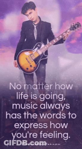 A Man In A Suit And Tie Is Holding A Guitar With A Quote On It GIF