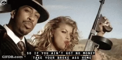 A Man In A Suit And Tie Is Holding A Gun Next To A Woman Who Is Blowing A Kiss . GIF