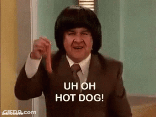 A Man In A Suit And Tie Is Holding A Hot Dog In His Hand . GIF