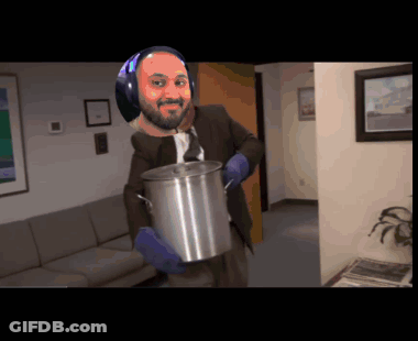 A Man In A Suit And Tie Is Holding A Large Pot GIF