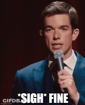 A Man In A Suit And Tie Is Holding A Microphone And Making A Funny Face . GIF
