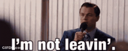 A Man In A Suit And Tie Is Holding A Microphone And Saying `` I 'M Not Leavin ' '' . GIF