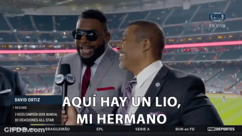 A Man In A Suit And Tie Is Holding A Microphone And Says Aqui Hay Un Lio Mi Hermano GIF