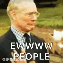 A Man In A Suit And Tie Is Holding A Microphone And Says Ewww People . GIF