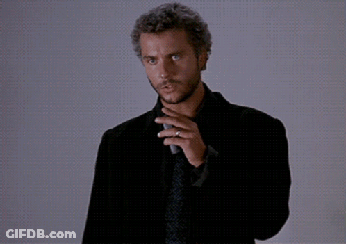 A Man In A Suit And Tie Is Holding A Microphone And Says " This Is My Design " GIF