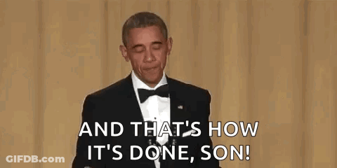 A Man In A Suit And Tie Is Holding A Microphone In His Hand And Talking Into It . GIF