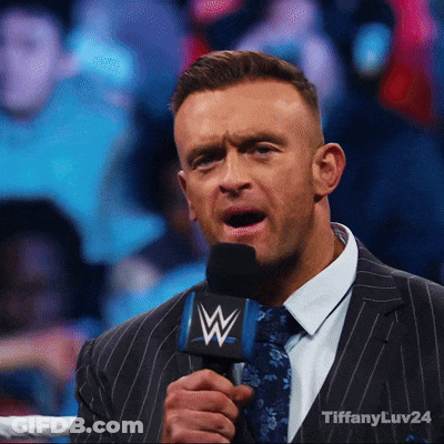 A Man In A Suit And Tie Is Holding A Microphone That Says Tiffanyluv24 GIF