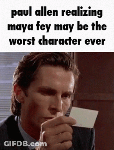 A Man In A Suit And Tie Is Holding A Piece Of Paper And Making A Funny Face . GIF